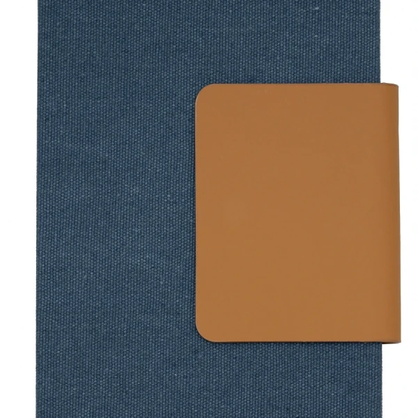 Front view of a dark blue textured notebook with a wide tan flap